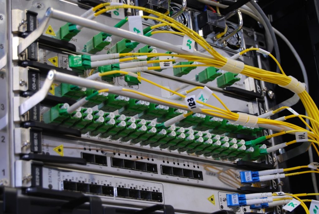 green-and-white-electric-device-evwwr6nmdf8 Optic-fiber telecommunication equipment in rack
